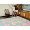 Two teachers standing on a SensoryEdge rug with pink and black designs in a school room.