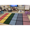 Pop of Color  grid rug in a classroom setting with educational materials and furniture.