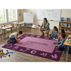 Children and teacher in a classroom with a purple 'engineering' themed rug.