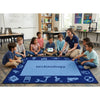 Teacher and students in a classroom with a 'technology' rug
