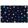 A rectangular area rug with a dark navy black background covered in a scattered pattern of stars in white, yellow, teal, and light purple, shown flat against a white background.