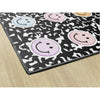 Smiley face patterned rug on a wooden floor