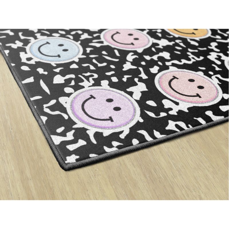 Smiley face patterned rug on a wooden floor