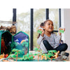 Child playing with toy set in a room with large windows