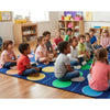 Children sitting in a circle on a colorful carpet in a classroom.