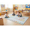 Children playing on a colorful rug in a classroom setting