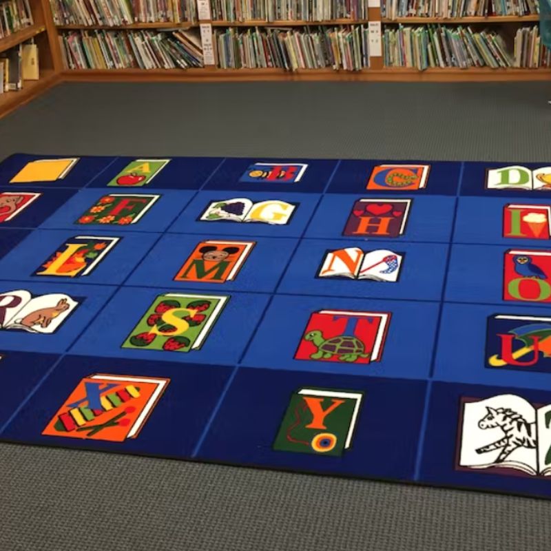 The Reading by the Book Rug was designed specifically for library and school reading or circle time spaces. Each letter of the alphabet is displayed on its own book with a cute image helping children connect the sound of each letter. 